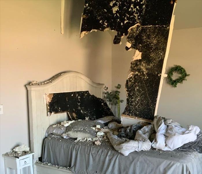 Child's bedroom with ceiling coming down after house fire